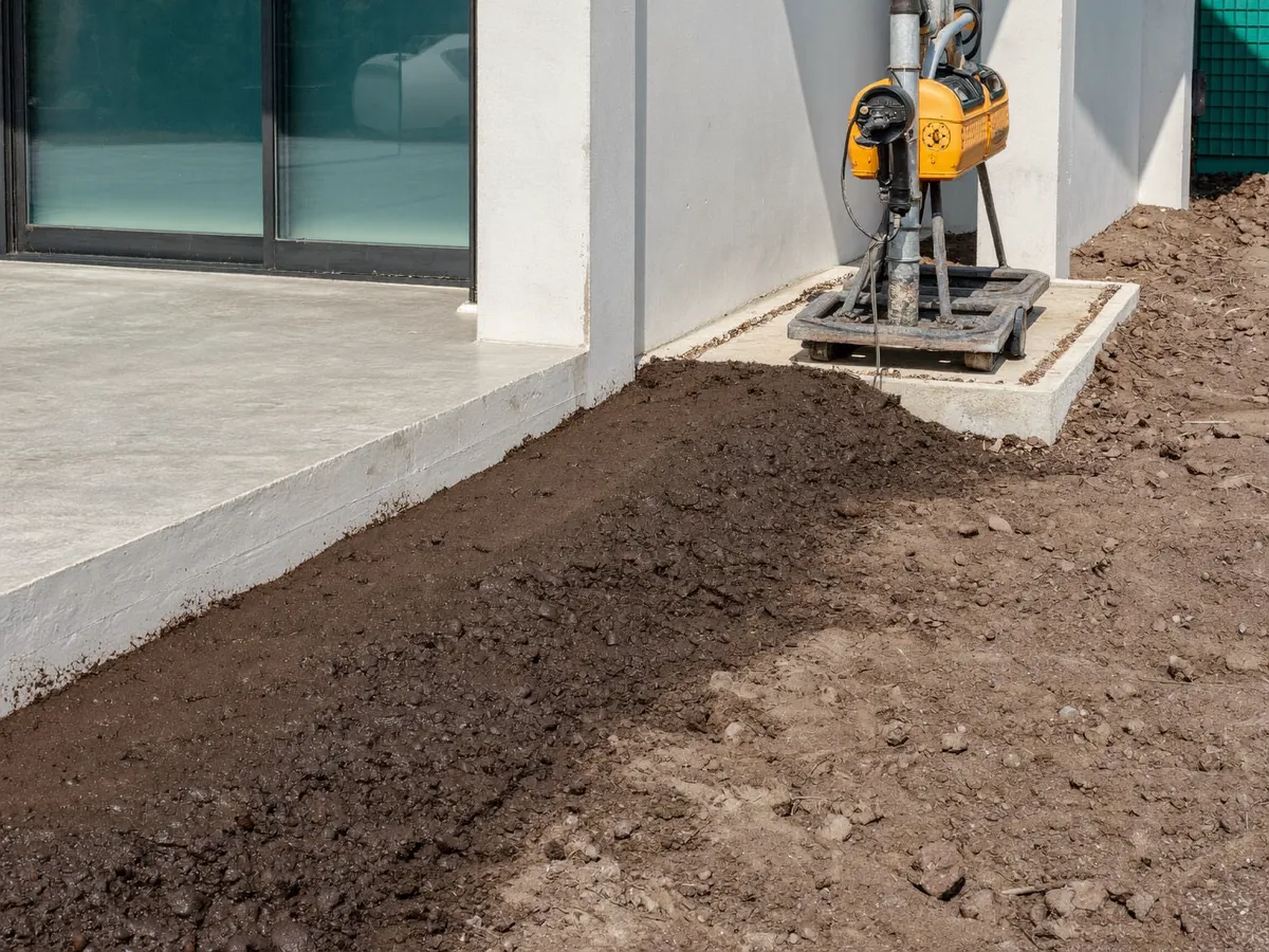 Anti-termite soil treatment along a villa foundation in Bali